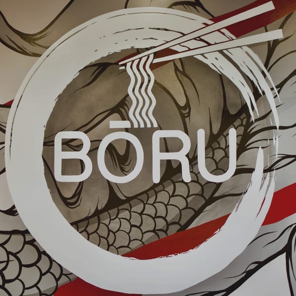 Boru Ramen logo with chopsticks holding noodles inside a white circle, over a dragon pattern.