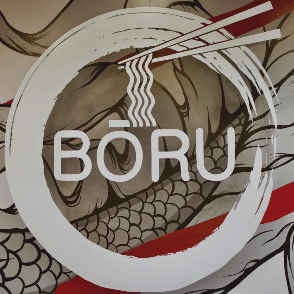 Boru Ramen logo with chopsticks holding noodles inside a white circle, over a dragon pattern.