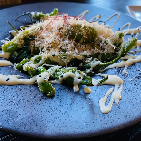 Boru Ramen's green shishito peppers with white sauce, sesame seeds, and shaved bonito flakes.