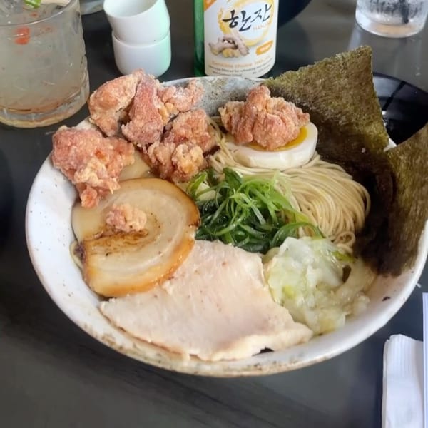 A bowl of Boru Ramen with fried chicken, pork, egg, noodles, and seaweed.